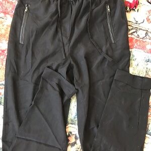 Silky light pants with faux leather waist and zipper pockets. Drawstring top